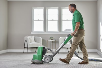 Technician cleaning carpets using the Powerhead